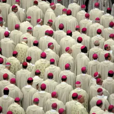 Tłum duchownych w białych szatach i różowych biretach, przypominający scenę z Soboru Watykańskiego II.