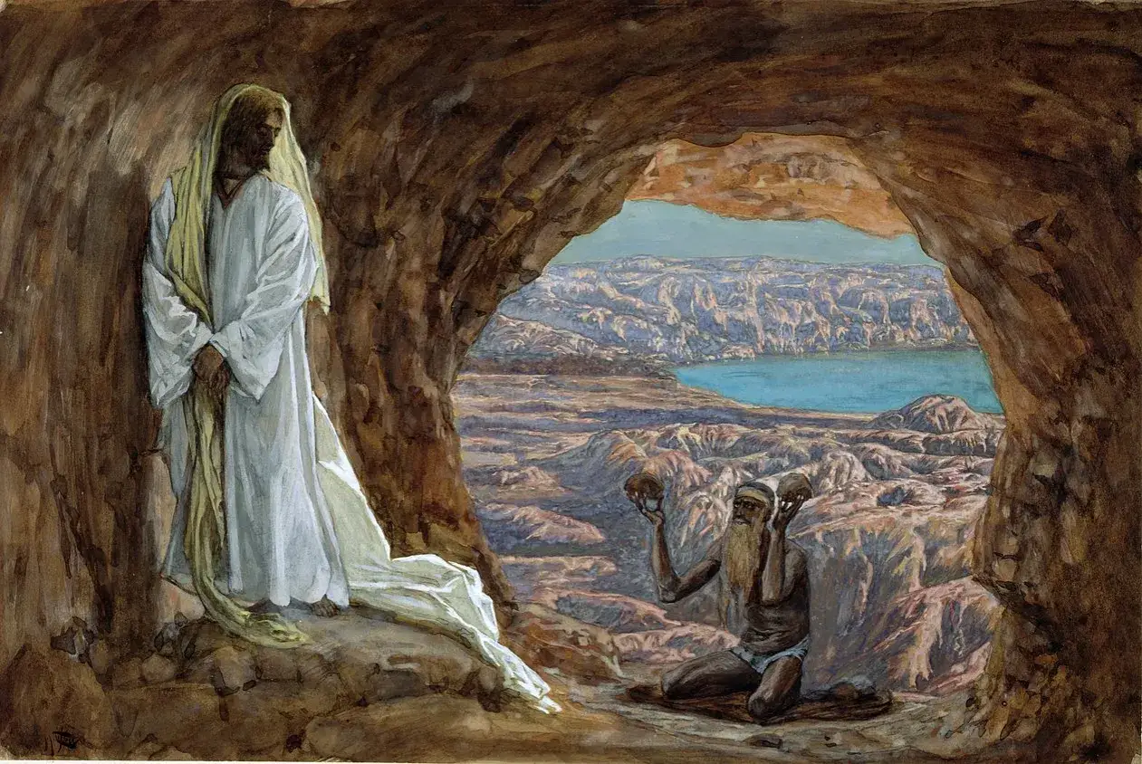 Jezus na pustyni, w białej szacie, stoi w jaskini. Na zewnątrz, w skalistym krajobrazie, klęczy prorok z czaszkami w dłoniach.